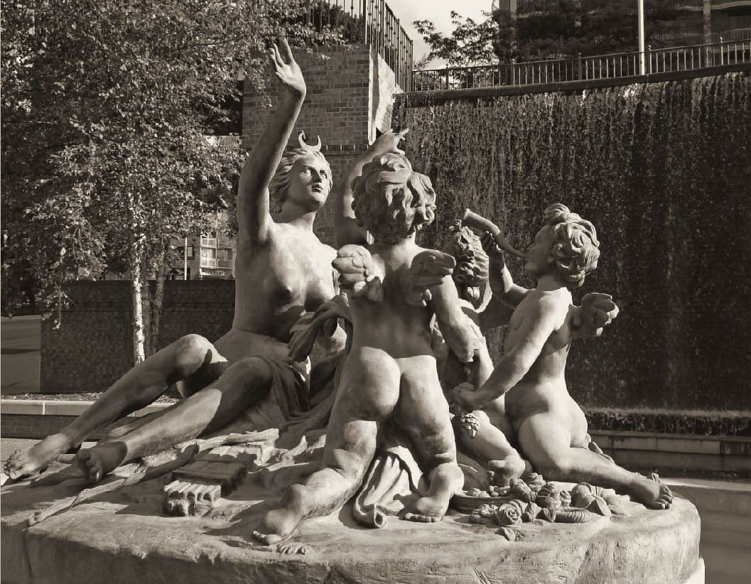 Warm-toned black and white print of a marble group of Diana and cherubs beneath a waterfall wall.