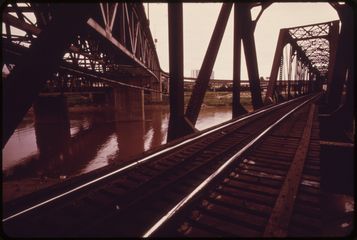 A rail track running out along a steel truss bridge at the inner city viaduct.